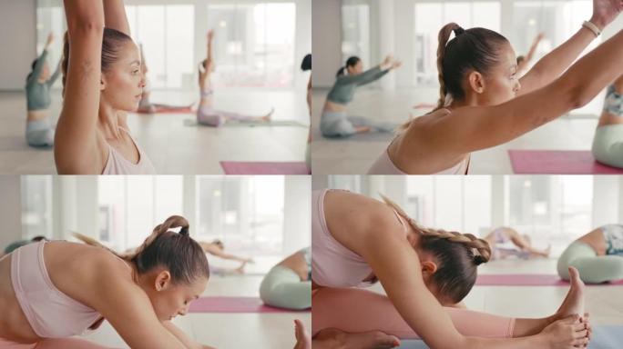 在明亮的工作室里，做瑜伽的女性在垫子上伸展，一群年轻灵活的女性在平静的健康中心或女性静修中心做冥想和