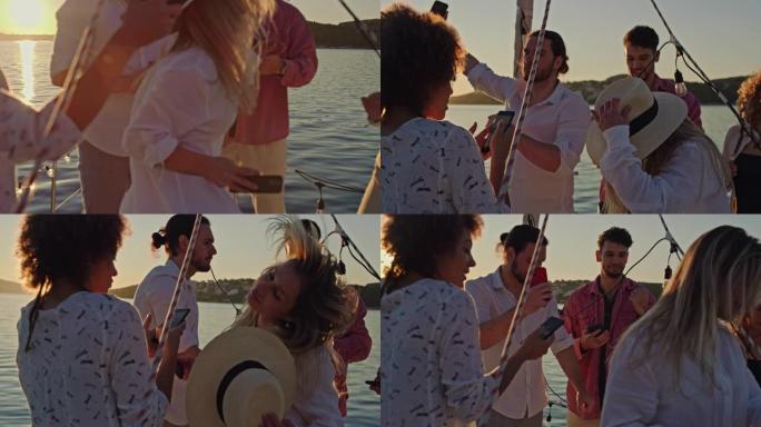 SLO MO一群朋友在日落时在船上的甲板上跳舞时自拍