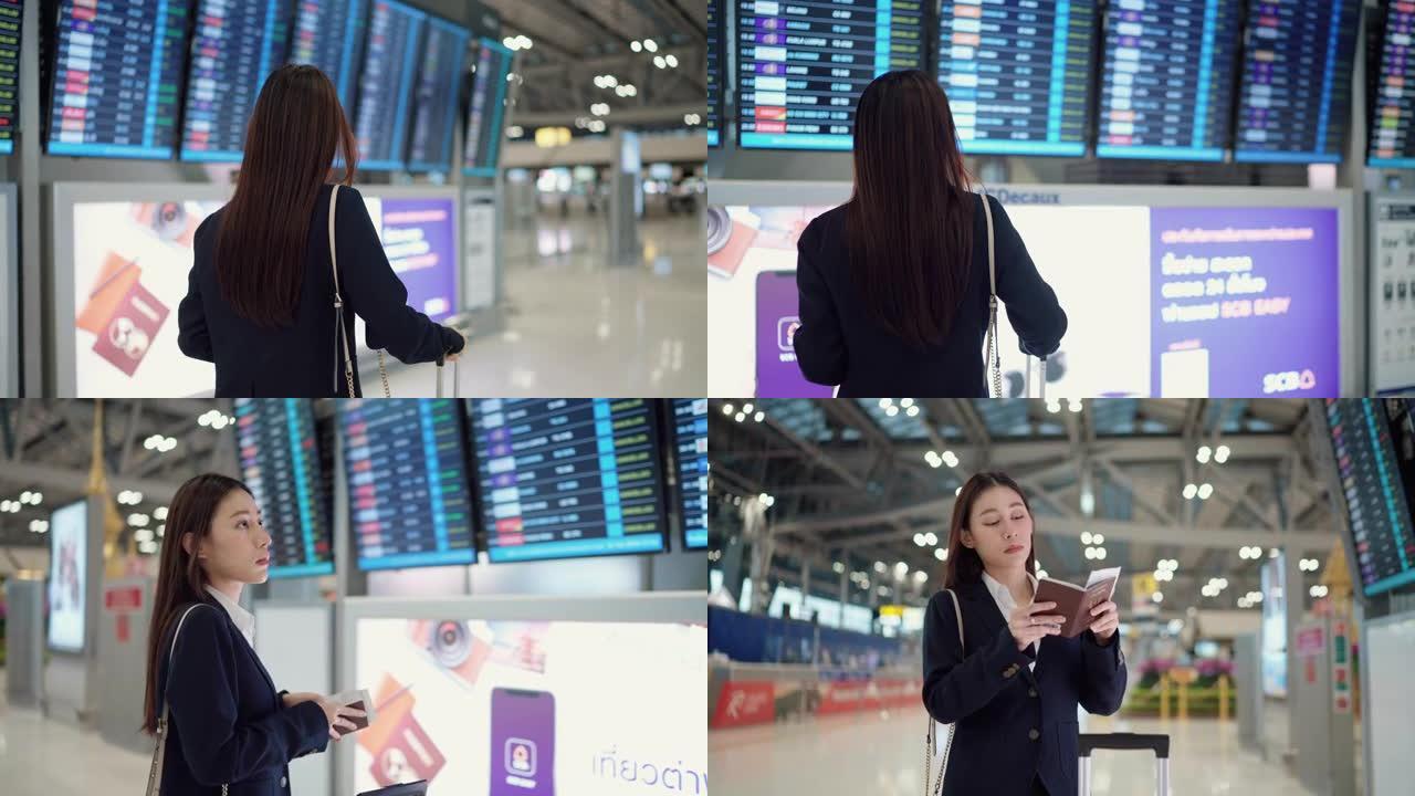 亚洲雇员带着她的手提箱准备在机场旅行