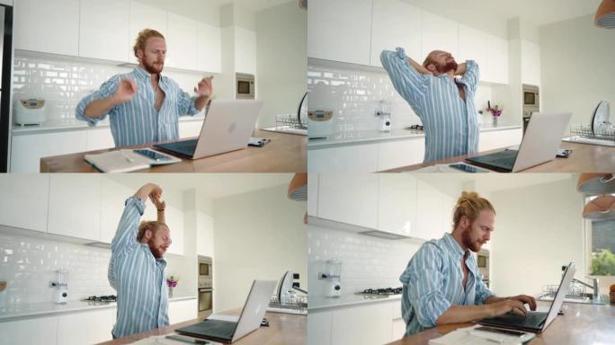 男子在家工作时伸展身体