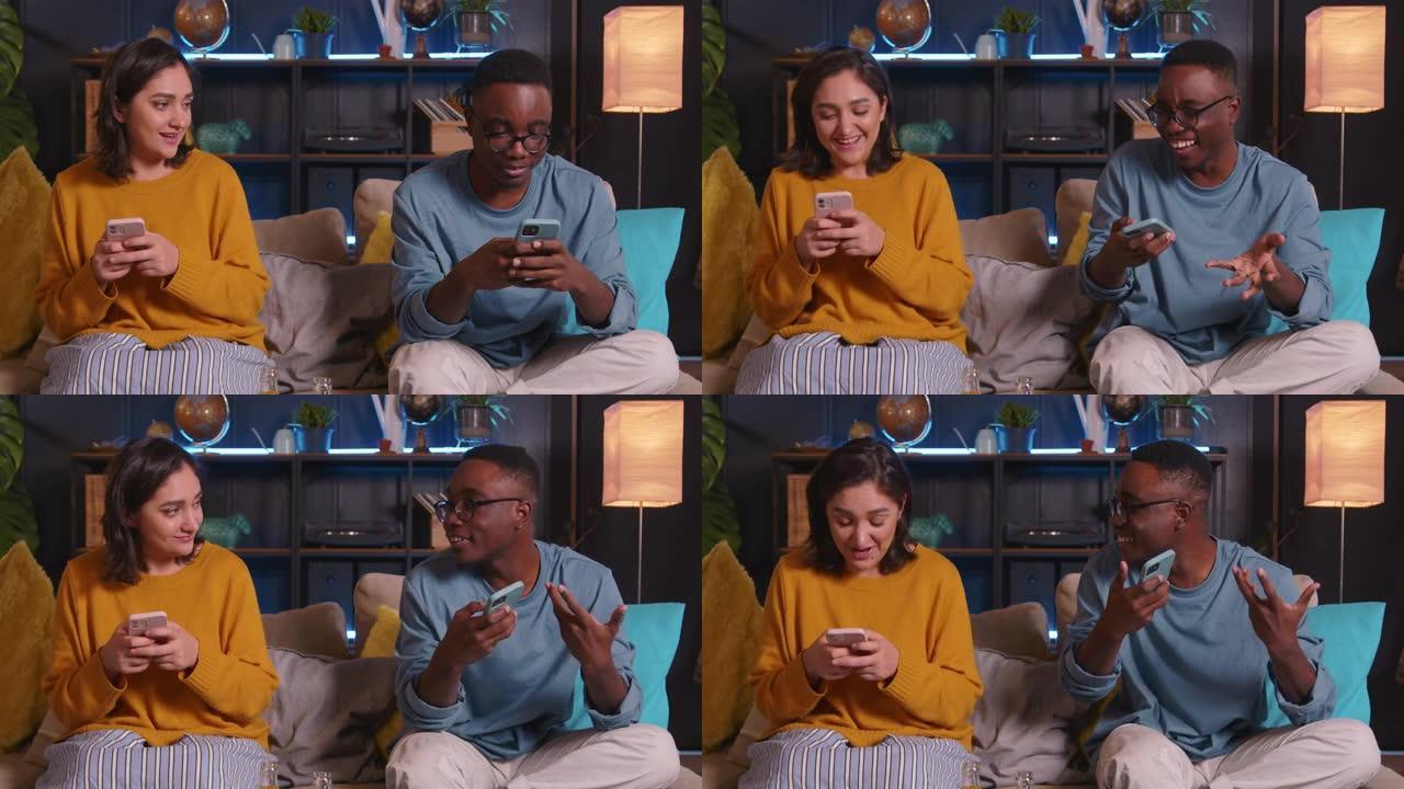 有趣快乐的年轻微笑的多民族男女朋友在沙发上在家休息时互相玩手机游戏。