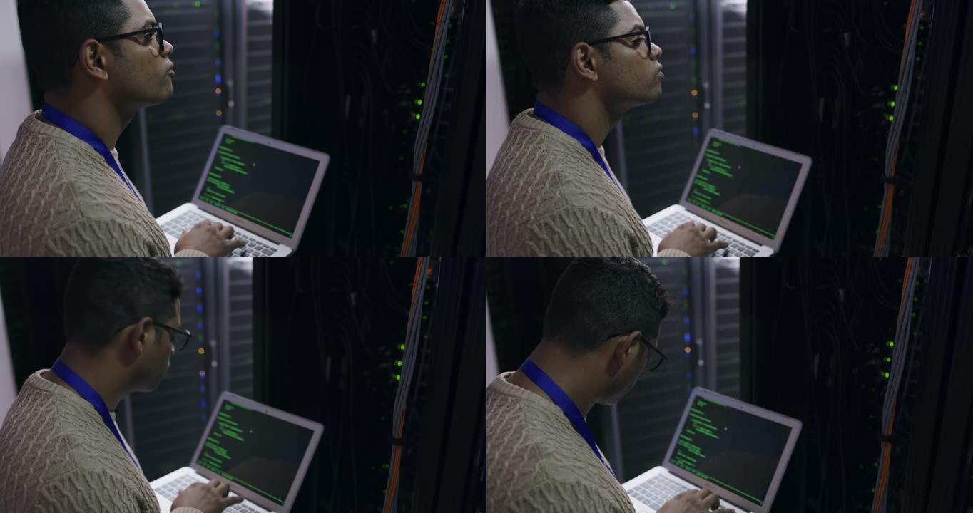 一名年轻技术人员在服务器机房使用笔记本电脑的4k视频片段