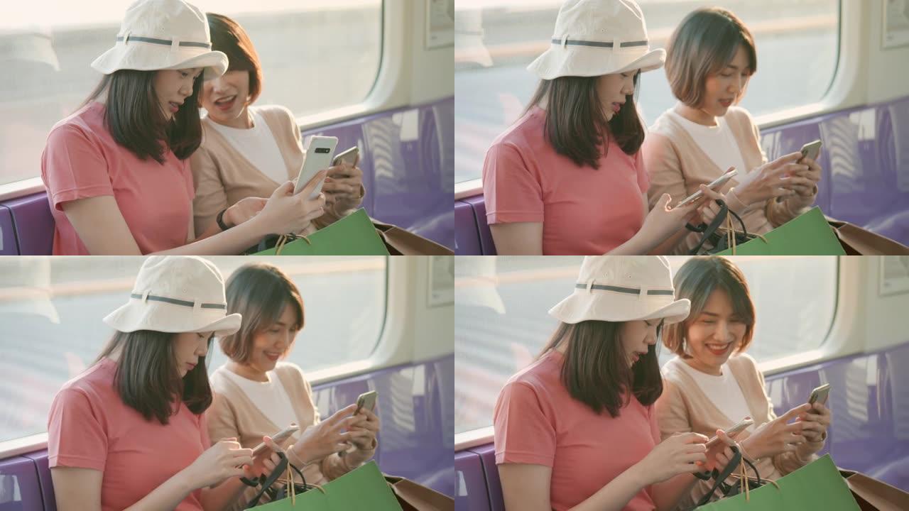 两名亚洲妇女在火车上旅行时说话和使用智能手机，慢动作