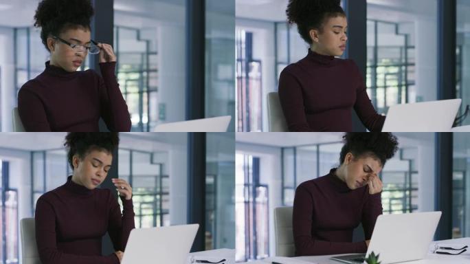 4k视频片段，一名年轻的女商人在现代办公室使用笔记本电脑时显得压力很大