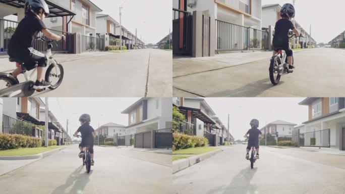 一个亚洲小男孩骑自行车快乐。