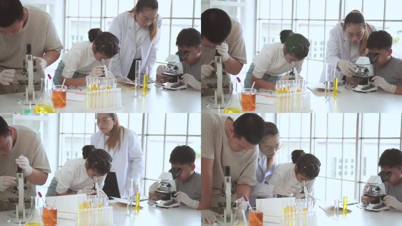 学生们高兴地用显微镜学习科学科目。