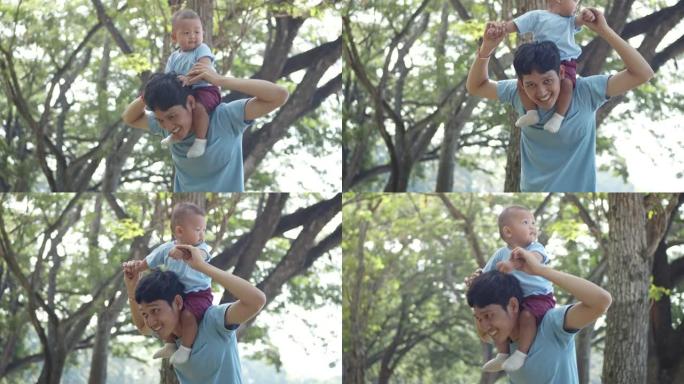 快乐的父亲在公园里玩耍和抱着儿子