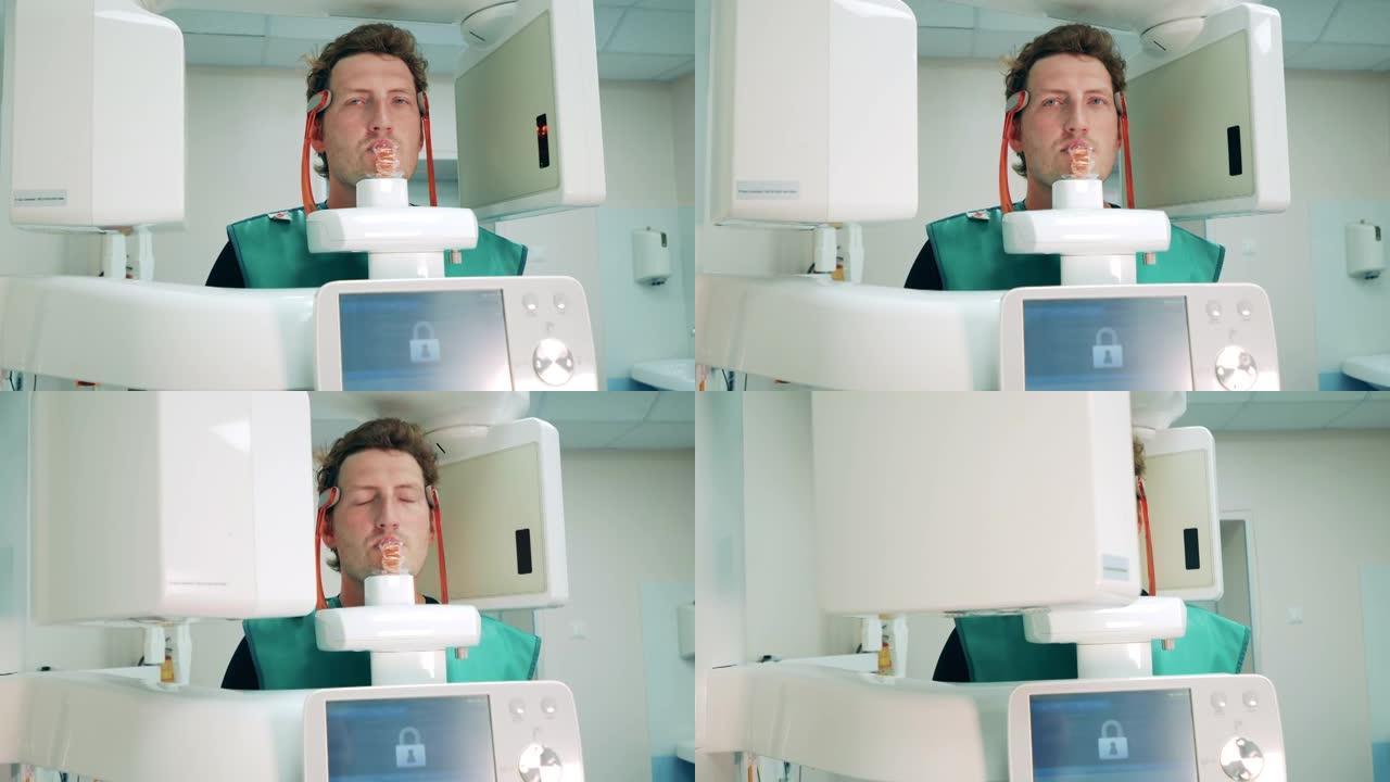 一个男人在诊所对他的牙齿进行x光检查