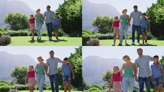 在阳光明媚的日子里，高加索家庭一起在花园里散步
