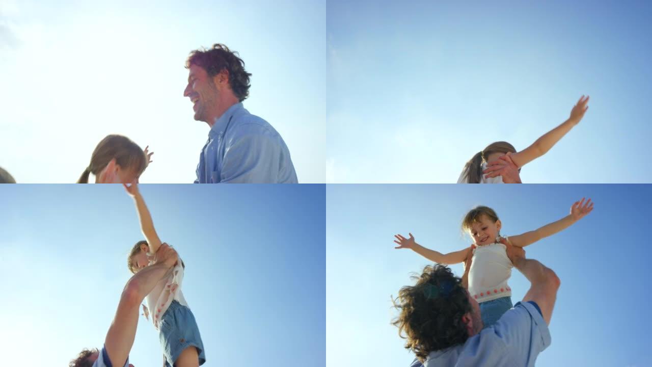 4k视频片段，父亲将女儿在海滩上抬起