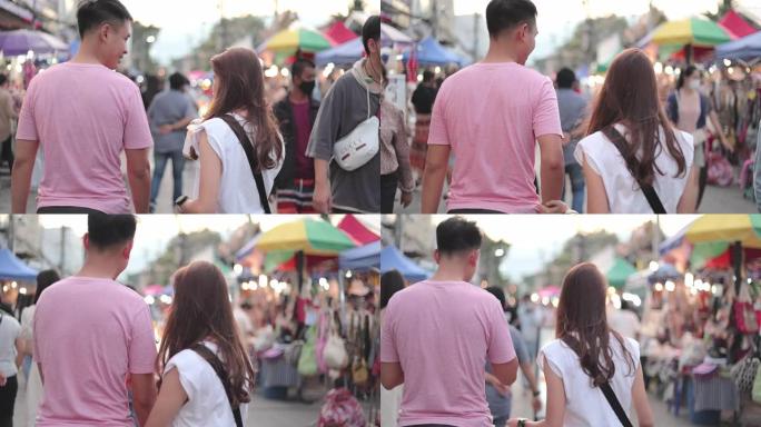 SLO MO年轻的亚洲夫妇在街头食品市场购物