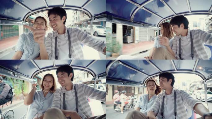 曼谷骑嘟嘟车的旅游夫妇