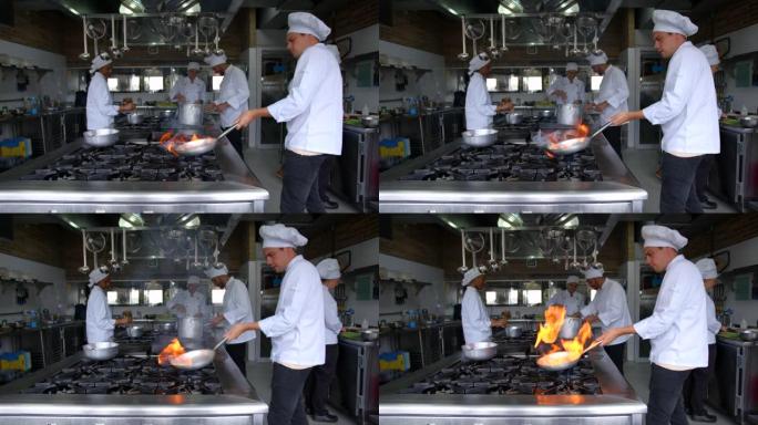 拉丁美洲厨师在商用厨房做饭，在平底锅里炒菜