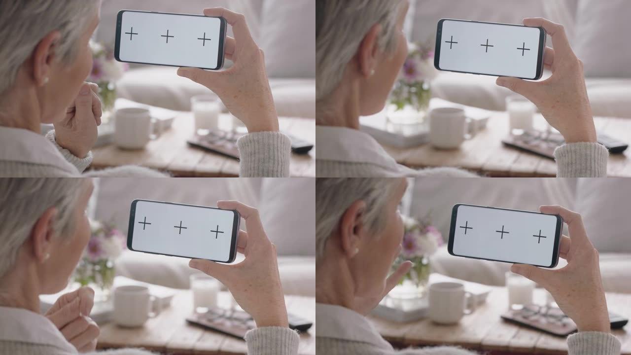 成熟的女人使用智能手机进行视频聊天绿屏聊天看起来很惊讶享受色度键显示水平方向4k镜头上的移动通信