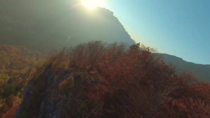 空中飞行在崎mountain的山区地形和山谷上方，秋天色彩绚丽