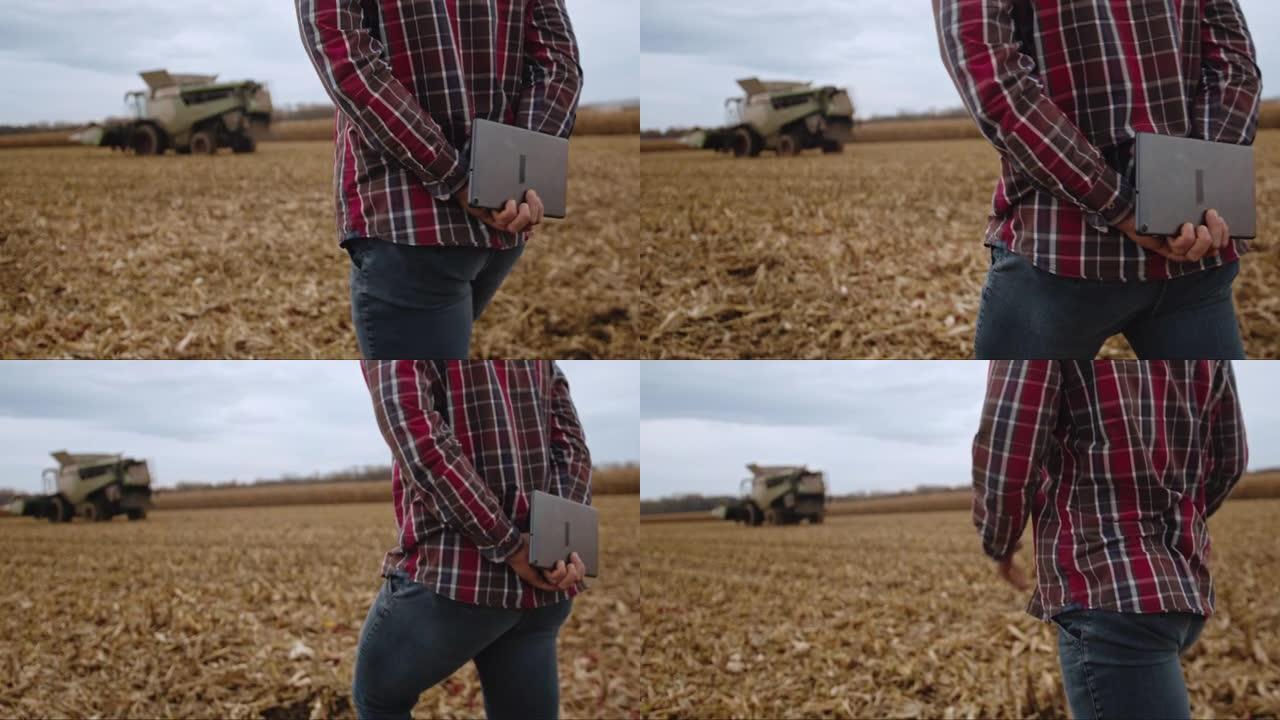 男子在农场散步时拿着数字平板电脑