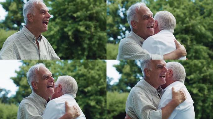 一位富有表现力的老人在绿色公园的一次情感聚会中与他的老朋友见面。两名年长的兄弟拥抱并表达了他们的激动