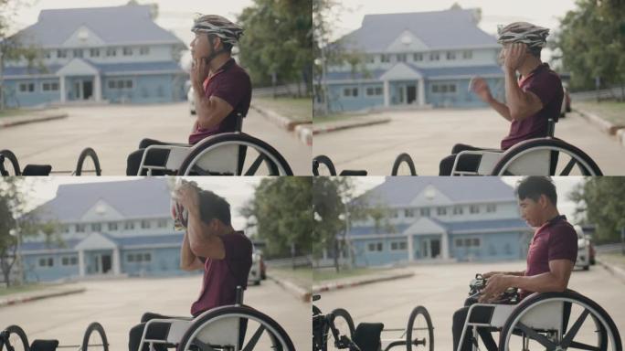 亚洲男子适应性运动员训练后坐在轮椅上。