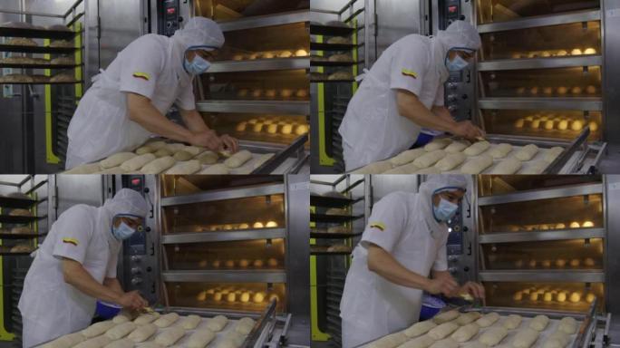 在食品加工厂工作的拉丁美洲人在将托盘添加到烤箱之前先烤面包并进行装饰