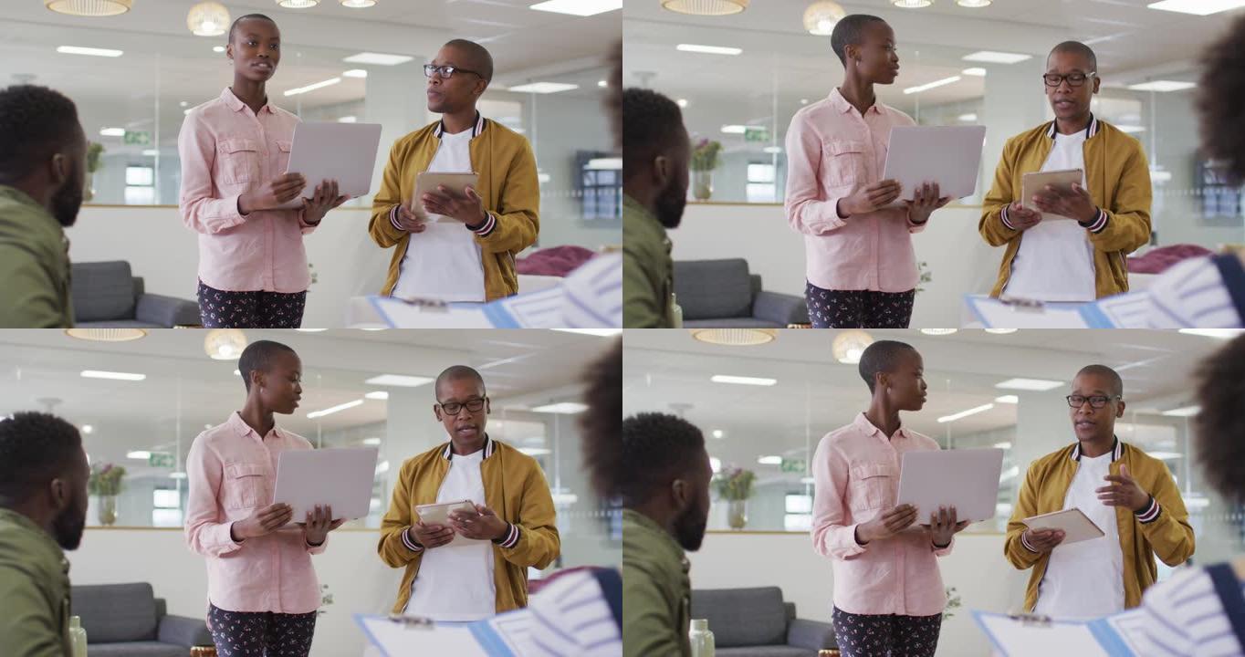 一群男女非裔美国同事在办公室进行商务谈话