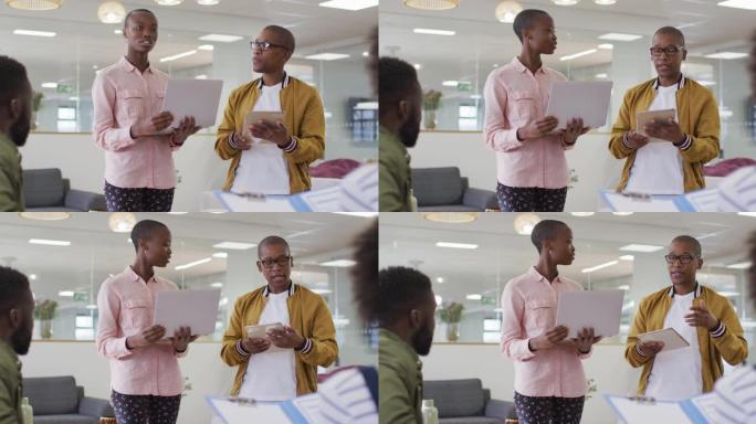 一群男女非裔美国同事在办公室进行商务谈话