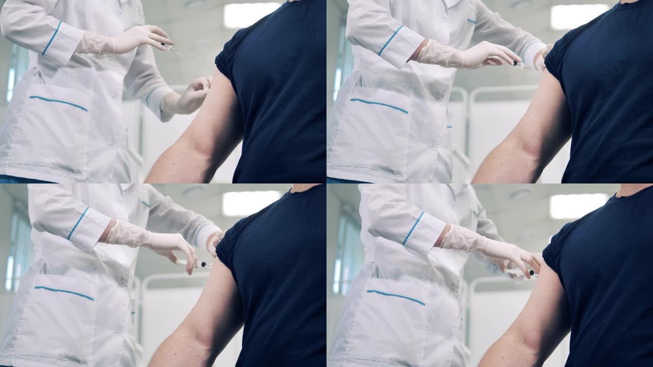 医生正在向患者的手臂注射疫苗