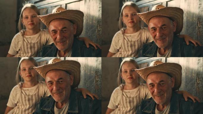 祖父和孙女在马stable里看着相机
