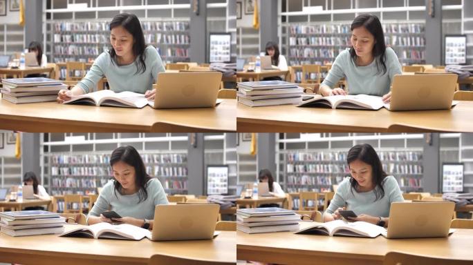 专注于亚洲女性的年轻学生在图书馆读书