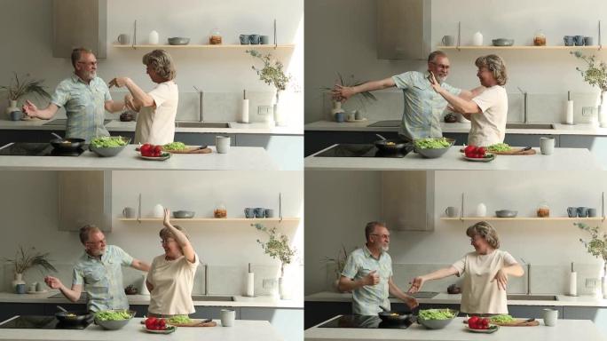 活跃的老年配偶养老金领取者在家庭厨房跳舞有趣的舞蹈