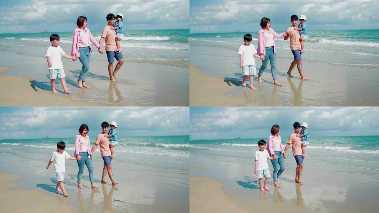 亚洲家庭在日落时在沙滩上奔跑，心情愉快
