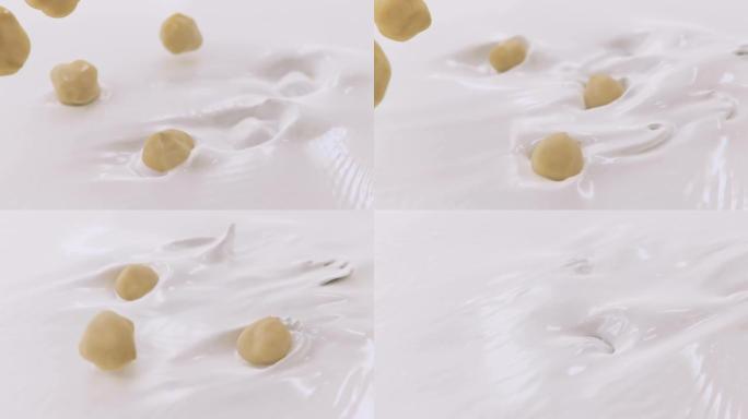 榛子在4k超慢动作中溅入液体奶油中