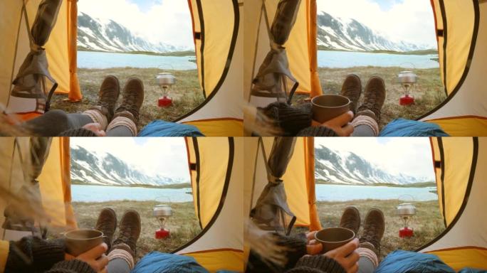 4k视频片段，一个无法识别的女人独自坐在帐篷里，在挪威喝杯咖啡