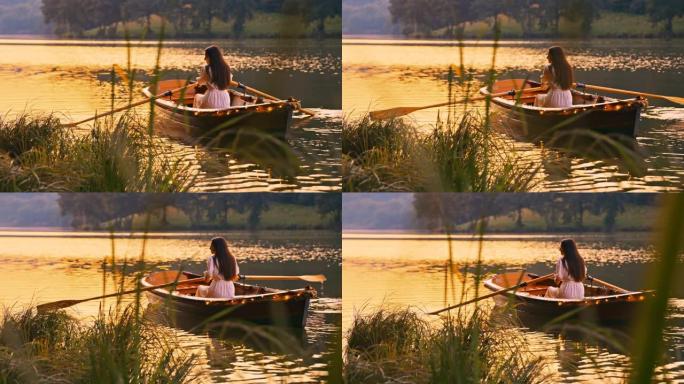 日落时分，一艘装饰好的小船在湖上划船的慢动作年轻女子
