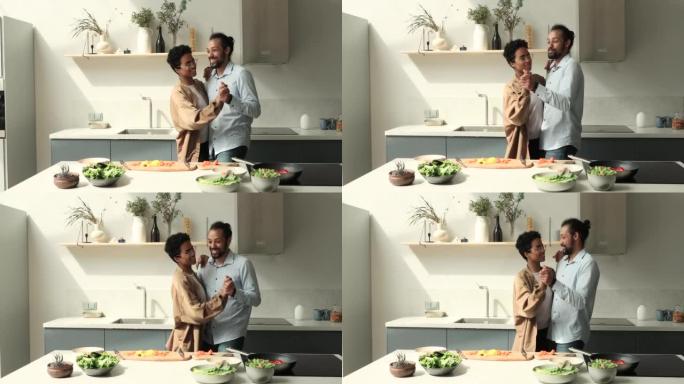 迷恋的黑人夫妇在慢舞中放松烹饪动作