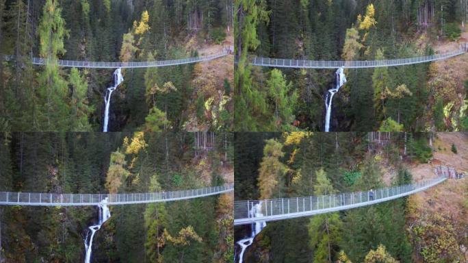 悬索桥的空中拍摄，在一个神奇、放松和绿色的地方，瀑布被大自然包围，风景优美。