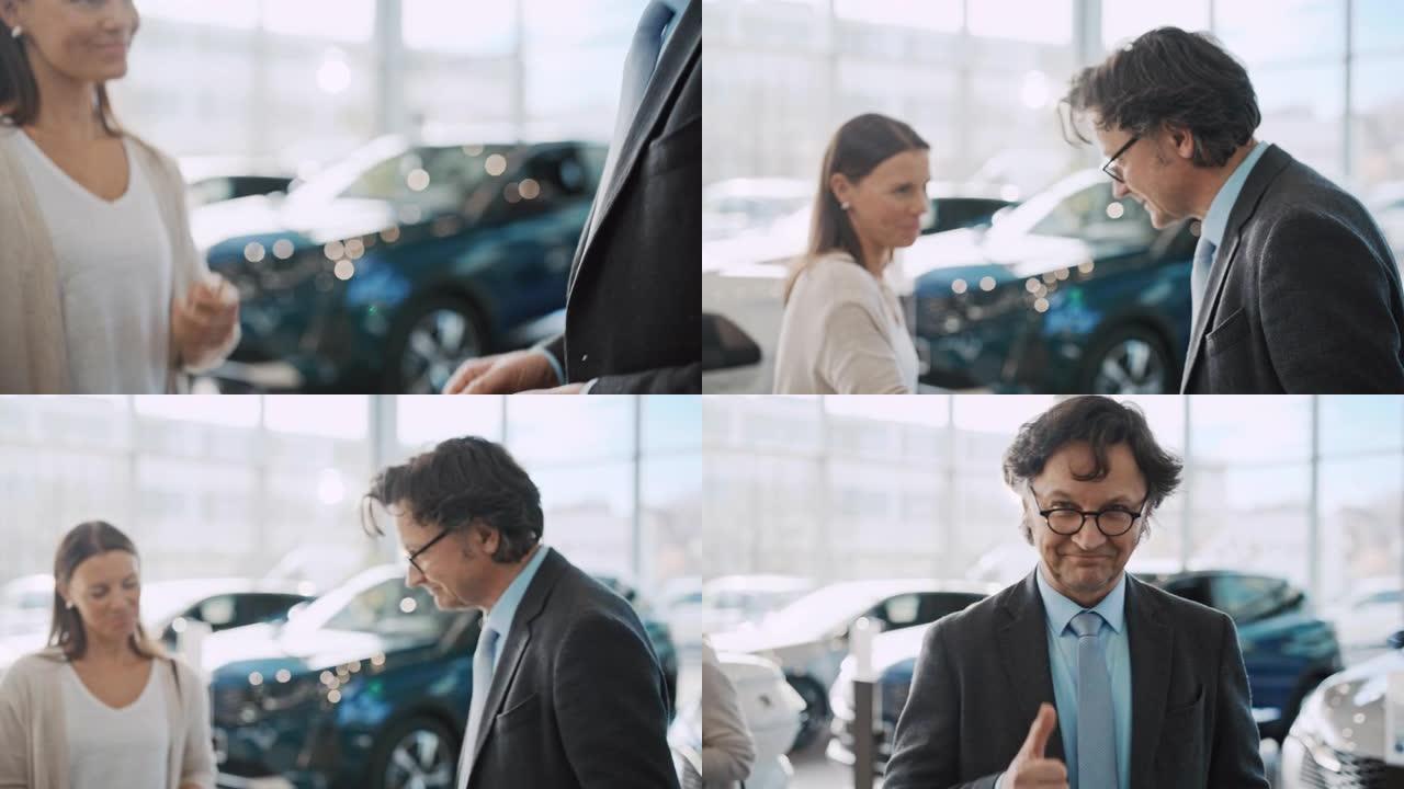 SLO MO汽车推销员交出钥匙并与一位女顾客握手