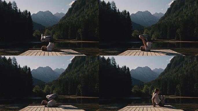 金发碧眼的女人在杰泽斯科美丽的池塘前的木板路上的马特练习瑜伽