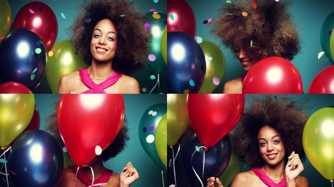 4k视频片段，一个快乐的年轻女子在气球的工作室背景下跳舞