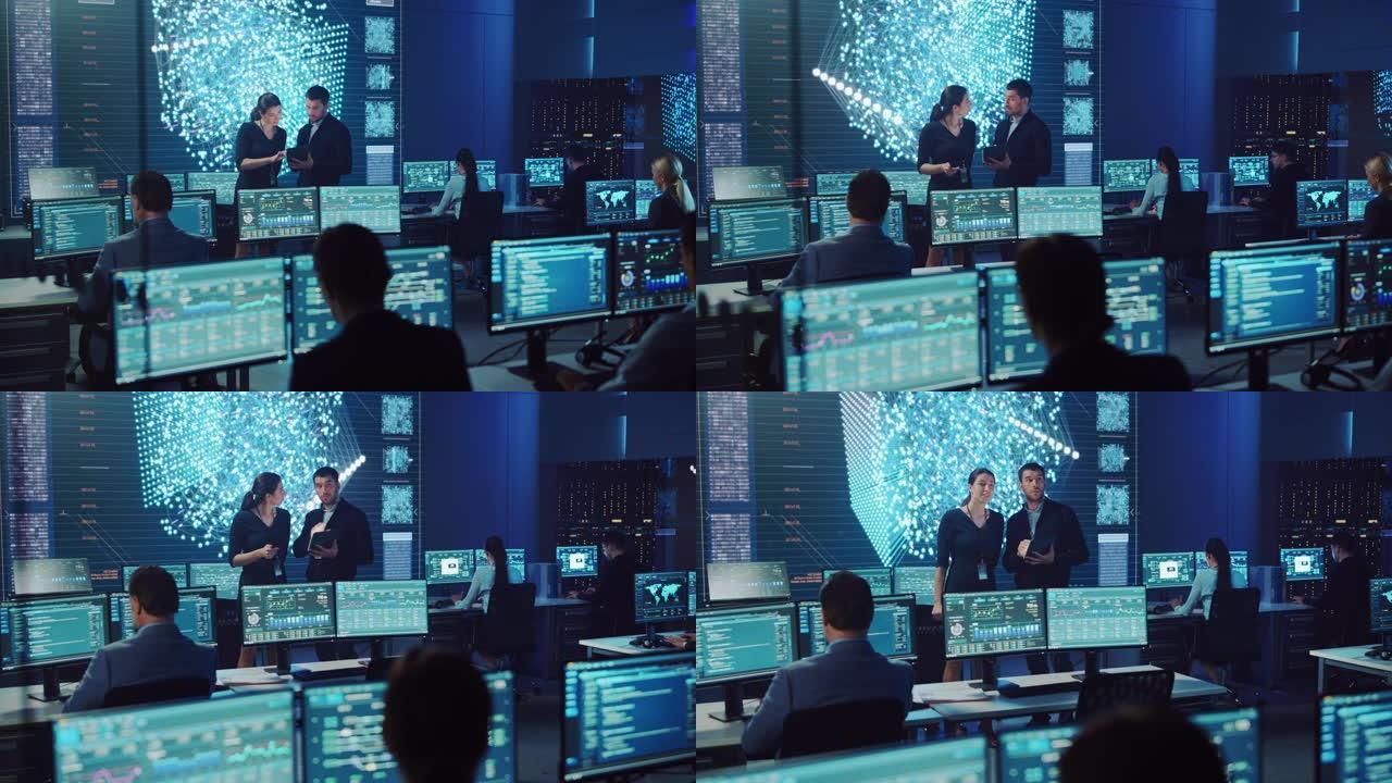 项目经理和计算机科学工程师在使用数字平板电脑时交谈。大屏幕神经网络电信系统控制监控室。