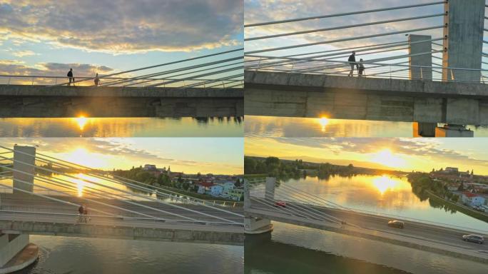 空中情侣在日落时在桥上骑电动滑板车