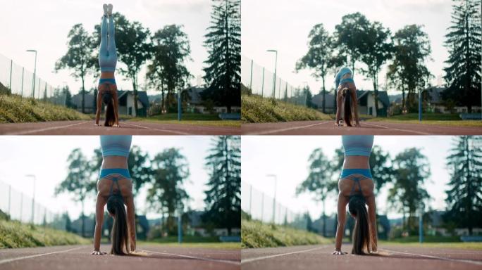 SLO MO运动年轻女子在跑道上练习倒立