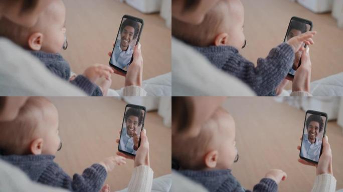 母亲和婴儿使用智能手机进行视频聊天，父亲在屏幕上挥舞着婴儿，享受通过手机连接与家人交流4k
