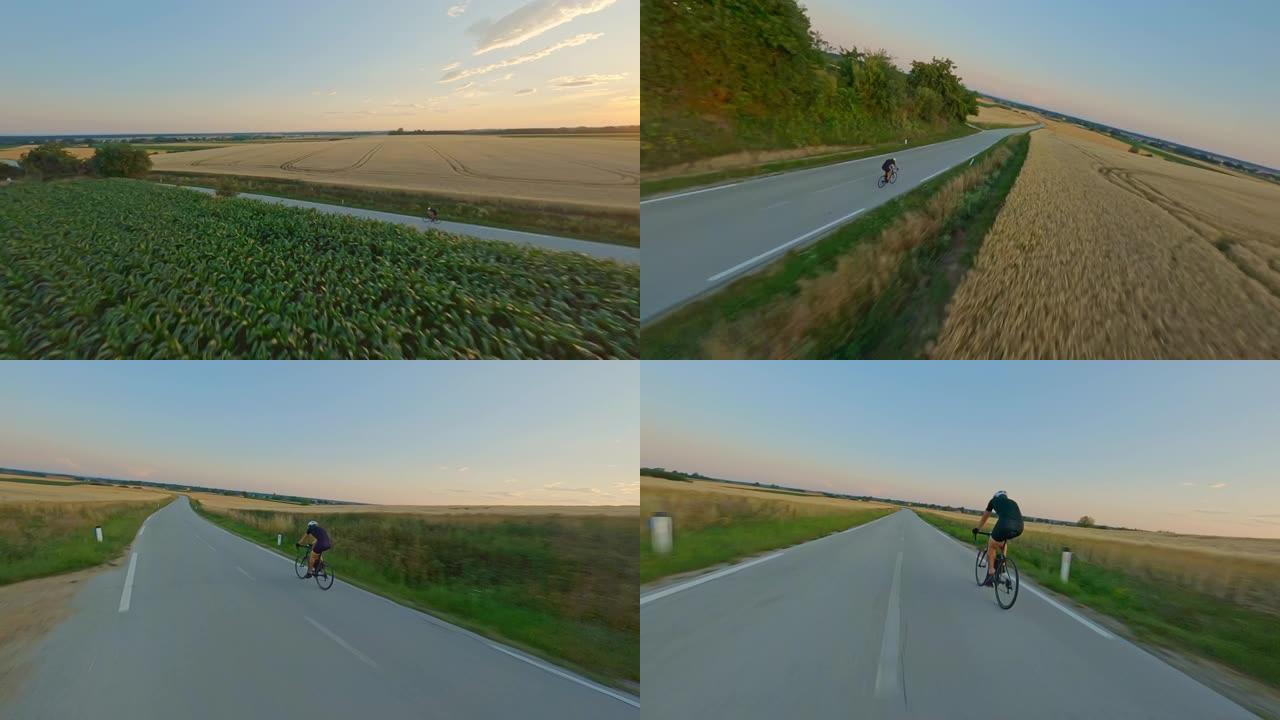空中专业自行车手在日落时分骑自行车穿越乡村