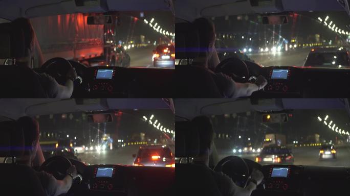 男人晚上在城里开车。变形镜头拍摄