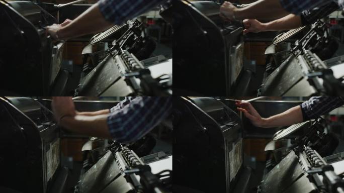 工匠造纸大师的慢动作特写正在与古董墨水打印机合作，在车间生产高质量的手工纸。以8K拍摄。手工制作、高