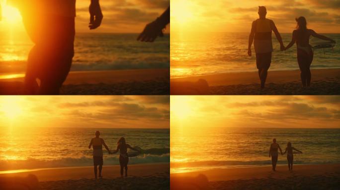 夫妻，女人和男人在日落时从海滩走到海边，手牵着手，女人在手臂下背着冲浪板，后视