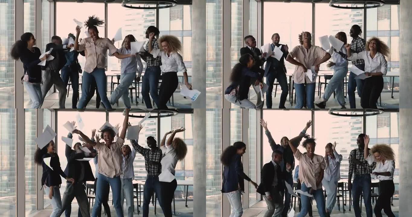 非洲族裔公司员工在办公室跳舞庆祝合作成功