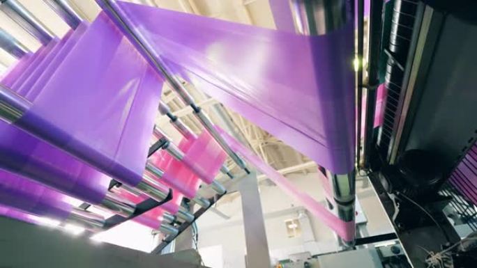 聚乙烯生产厂的彩色塑料袋制造机的底视图。聚乙烯袋生产。