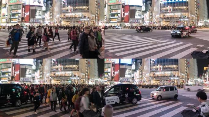 涩谷与许多行人和车辆在日本东京夜间穿越路口