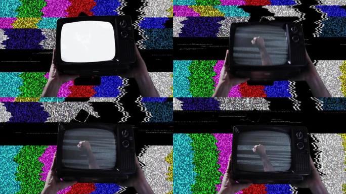 紧握的拳头在复古电视和彩色条作为背景。特写镜头。